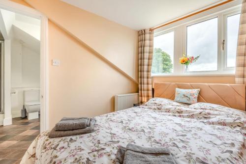 a bedroom with a bed and two windows at 1 Bed in Raithby oc-h42745 in Raithby