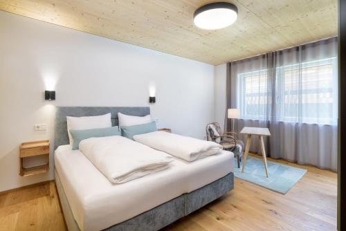 a bedroom with a large bed and a window at Gratzenthal Boutique Apartments in Hollenstein an der Ybbs