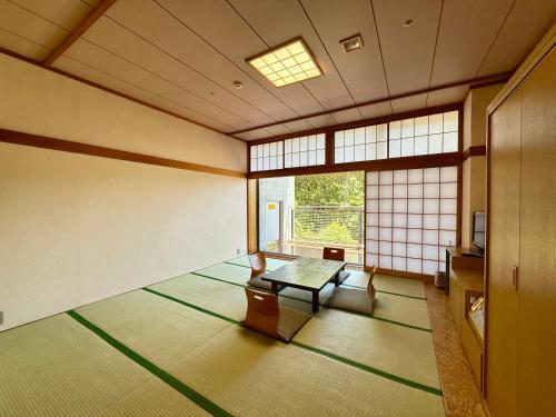 an empty room with a table and a window at WELLNESS PARK IWAKI Iwaki Yuttarikan in Iwaki