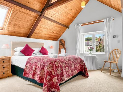a bedroom with a large bed and a window at Keld Apartment Porlock in Porlock