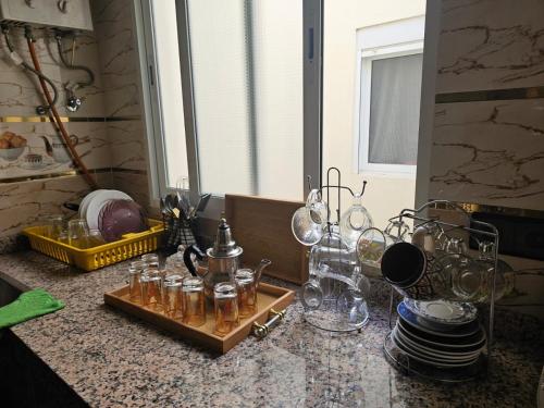 a counter top with jars and glasses on it at Belyounech in Belyounech 