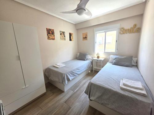 a bedroom with two beds and a window at PASARELA ALMOZARA HOME & Parking gratis in Zaragoza