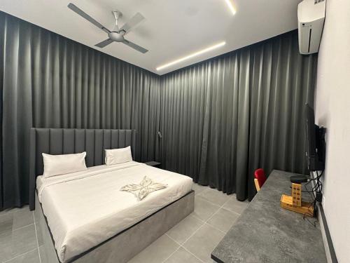 a bedroom with a bed and a ceiling fan at Hotel Siri Inn Hitech City in Hyderabad