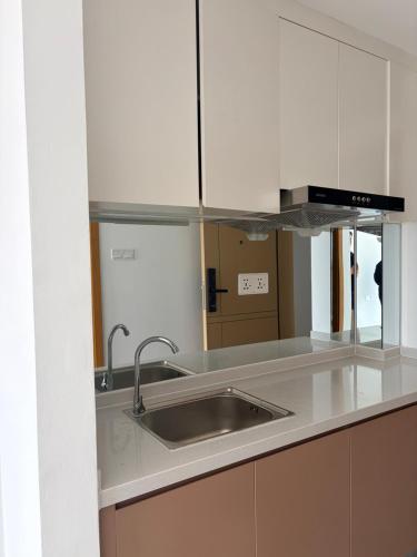 a kitchen with a sink and a mirror at FryB in Phnom Penh