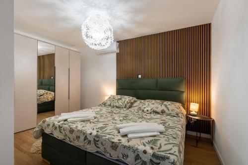 a bedroom with a bed and a chandelier at Kuća za odmor Leona in Dušić