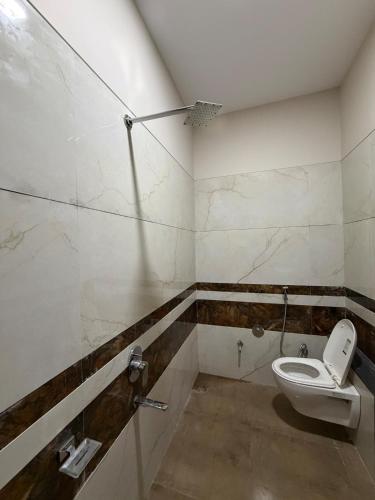 a bathroom with a toilet in a room at Hotel VITHAI PALACE in Mehekar