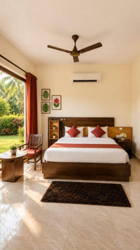 a bedroom with a large bed with a ceiling fan at Wildline Gold Resort in Dhikuli
