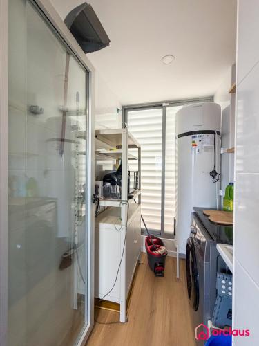 a kitchen with a white refrigerator and a window at Altamar Imperial in Cabanes