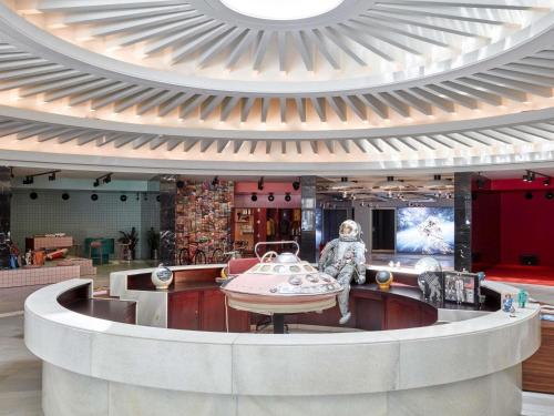 a lobby of a building with a statue in the middle at 25hours Hotel The Circle in Cologne