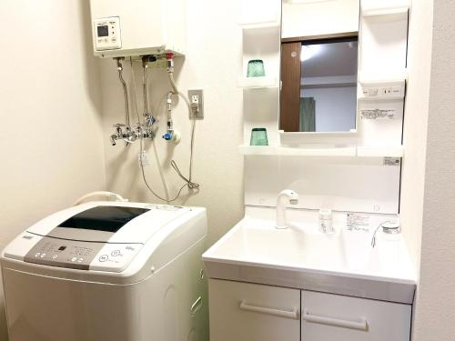 a bathroom with a washing machine and a sink at Hakodatekan - Vacation STAY 07899v in Hakodate