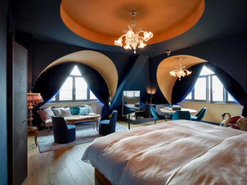 a bedroom with a large bed with arched ceilings at 25hours Hotel The Royal Bavarian in Munich