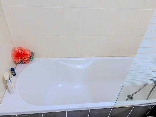 a bathtub with a red flower on top of it at La Beaujoire in Nantes
