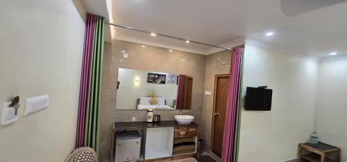 a bathroom with a sink and a mirror at Hotel KSR Grand in Srikalahasti