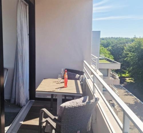 a balcony with a table and chairs on a balcony at Apartment Sonnendeck in Ulstrupfeld