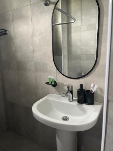 a bathroom with a white sink and a mirror at Gogasar house in Ijevan