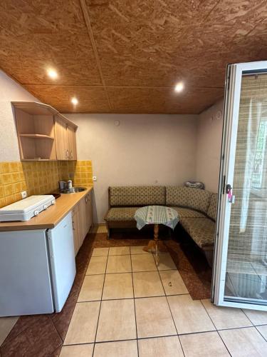 a kitchen with a couch and a table in a room at Ośrodek Wypoczynkowy Lido Noclegi in Antonin