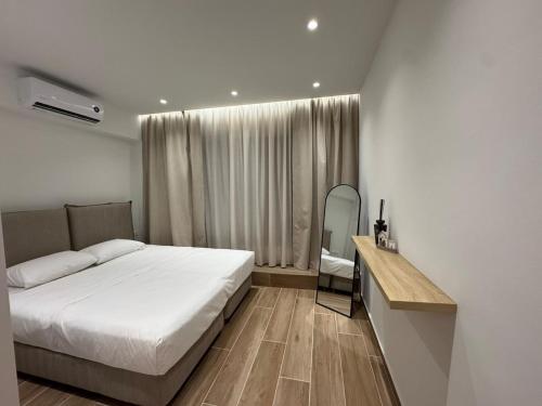 a bedroom with a bed and a desk in it at Kiato City Stay in Kiaton