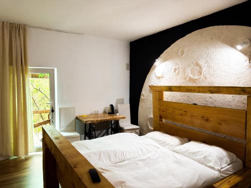 a bedroom with a large bed with a wooden headboard at Suputnyk in Rakhiv