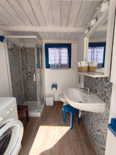a bathroom with a sink and a shower at Indigo Moon in Quartu SantʼElena