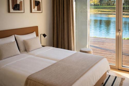 a bedroom with a bed and a large window at Amenity Usedlost v Marinkách in Blažejov