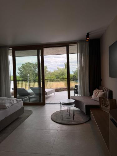 a living room with a couch and a table at Hotel Nationalpark in Illmitz
