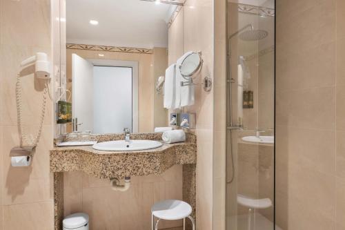 a bathroom with a sink and a shower at Mac Puerto Marina Benalmádena in Benalmádena