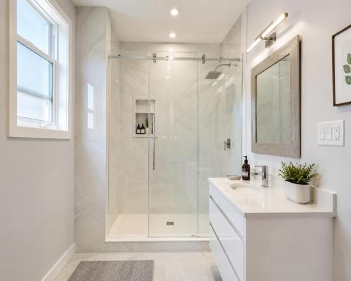 a white bathroom with a shower and a sink at Wonderful house in Niagara-on-the-Lake