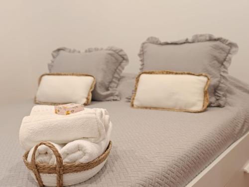 a bed with towels and a basket on it at Casa Teles in Peso da Régua