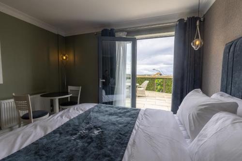 a bedroom with a bed with a view of a patio at Tara Hotel in Killybegs