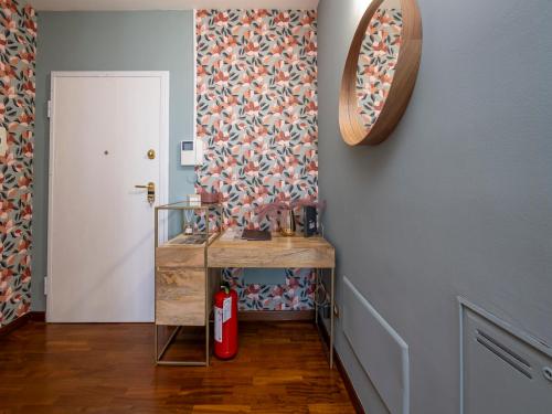 a hallway with a table and a mirror on the wall at NoLo Uptown Milano in Milan