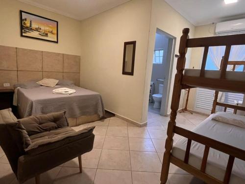 a bedroom with a bed and a bunk bed at Pousada Castelinho in São Sebastião