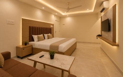 a hotel room with a bed and a couch at Hotel Vaarahi Chanda Nagar, Near Hitech City in Hyderabad