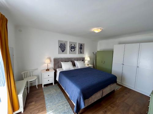 a bedroom with a bed with a blue blanket at Island Life in Mali Lošinj