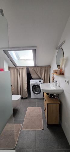 a bathroom with a sink and a washing machine at Casa Sole in Murg