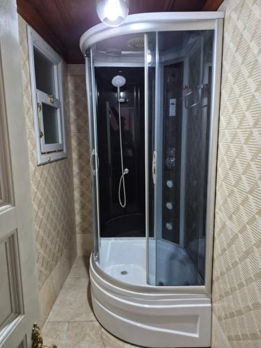 a shower with a glass door in a bathroom at Ali Paşa Konağı Sarıyer in Sarıyer
