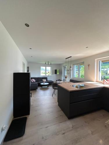 an open kitchen and living room with a couch at Appartement Bergblick Eben in Eben im Pongau