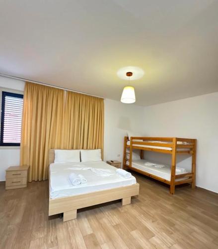 a bedroom with two beds and a bunk bed at Gregor Villa in Asim Zeneli