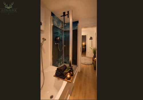 a bathroom with a shower and a bath tub at Gästezimmer Eifelglück - ohne Küche in Pelm