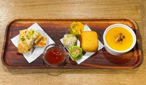 a tray with a plate of food and a bowl of soup at Energy Inn in Taipei