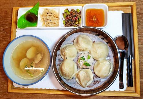 a tray of food with dumplings and a bowl of soup at Energy Inn in Taipei