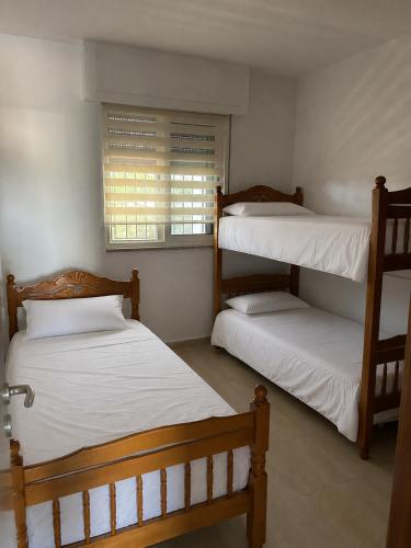 a room with two bunk beds and a window at Villa Keti in Velipojë