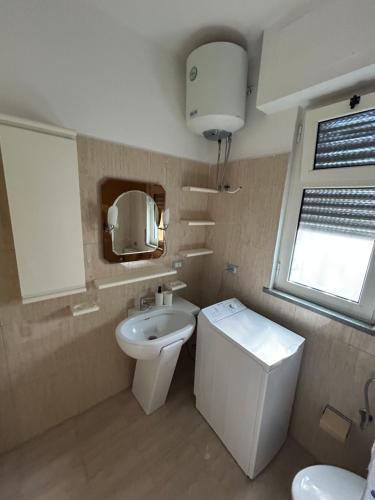 a small bathroom with a toilet and a sink at Villa Keti in Velipojë
