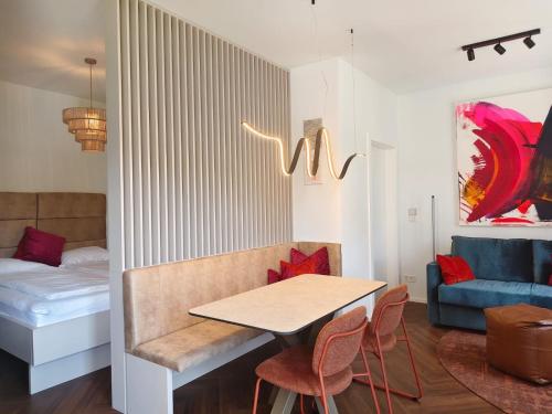 a living room with a table and a couch at Studios zur Schmiede in Weyregg