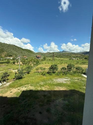 a view of a field with mountains in the background at Merlis Hotel in Kusarth