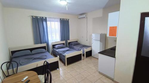 a small room with two beds and a kitchen at ℰ`ℋ Hotel - Velipoje rruga nr 7 in Velipojë