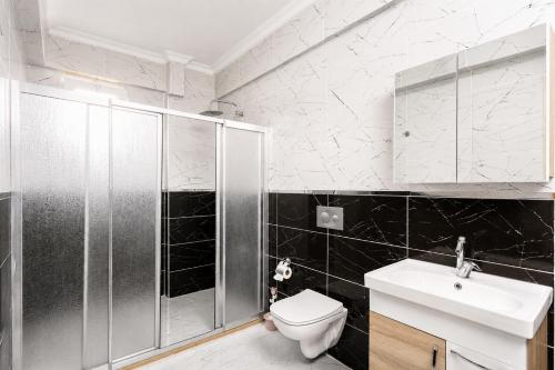 a bathroom with a shower and a toilet and a sink at Villa Azalea 2 in Ortaca