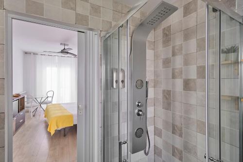 a bathroom with a shower with a glass door at Hostal Puente de Hierro in Logroño