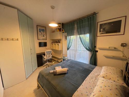 a bedroom with a bed and a desk and a window at B&B Imagine in Bari