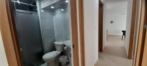 a bathroom with a toilet and a glass shower at Apartment Neiva Rasan in Neiva