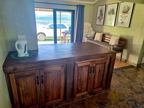 a wooden counter in a room with a living room at Korentepoort Dam in Riversdale